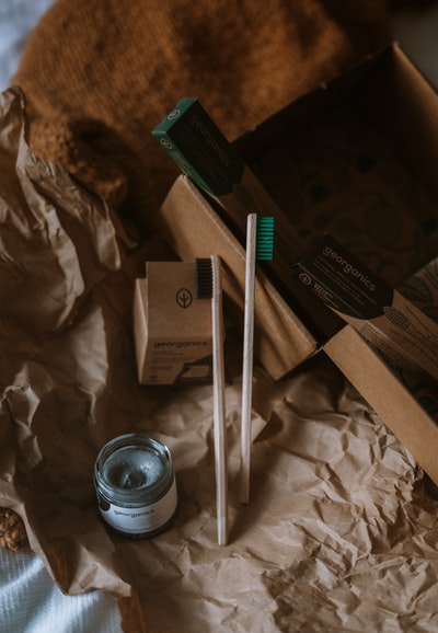 White and black, white and green ball-point pen beside the ceramic cup
